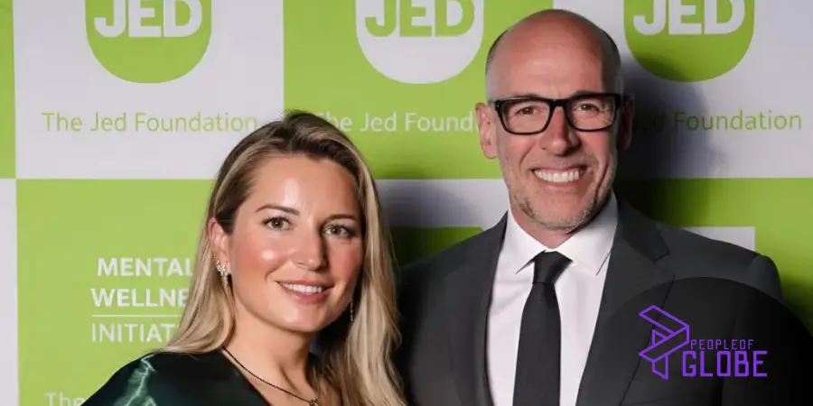 Beata Galloway attending a formal event with "The Jed Foundation" and "Mental Wellness Initiative" branding in the background.