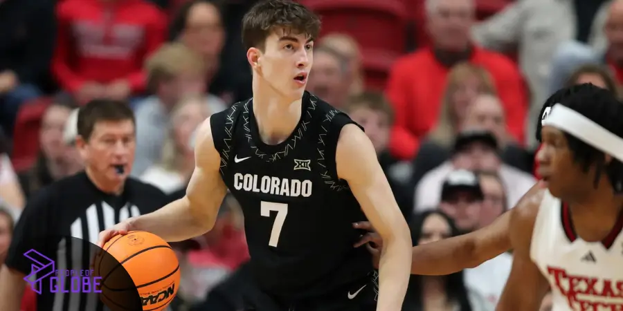 Jasper Breckenridge Johnson in a black Colorado basketball jersey #7 dribbling a ball during a game.