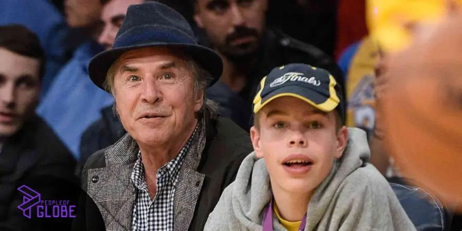 Don Johnson and his young son, Jasper Breckenridge Johnson, sitting courtside at a basketball game.