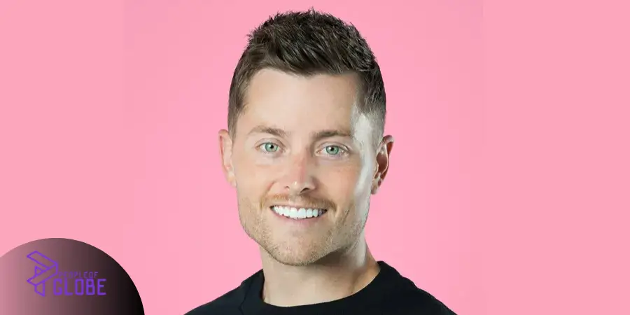 A high-quality professional headshot of Sawyer Hemsley, co-founder of Crumbl Cookies, against a pink background.