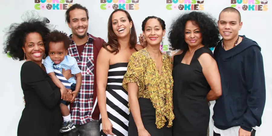 A wide group red carpet photo featuring music icon Diana Ross standing happily surrounded by her grown children, including daughters Tracee Ellis Ross and Rhonda Ross Kendrick, and sons Evan Ross and Ross Naess holding a toddler.
